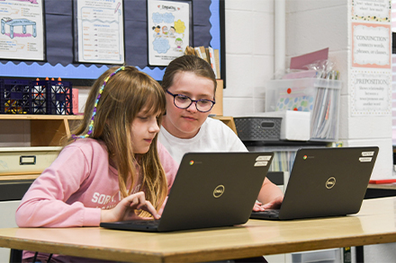 Two Girls Looking at a Computer