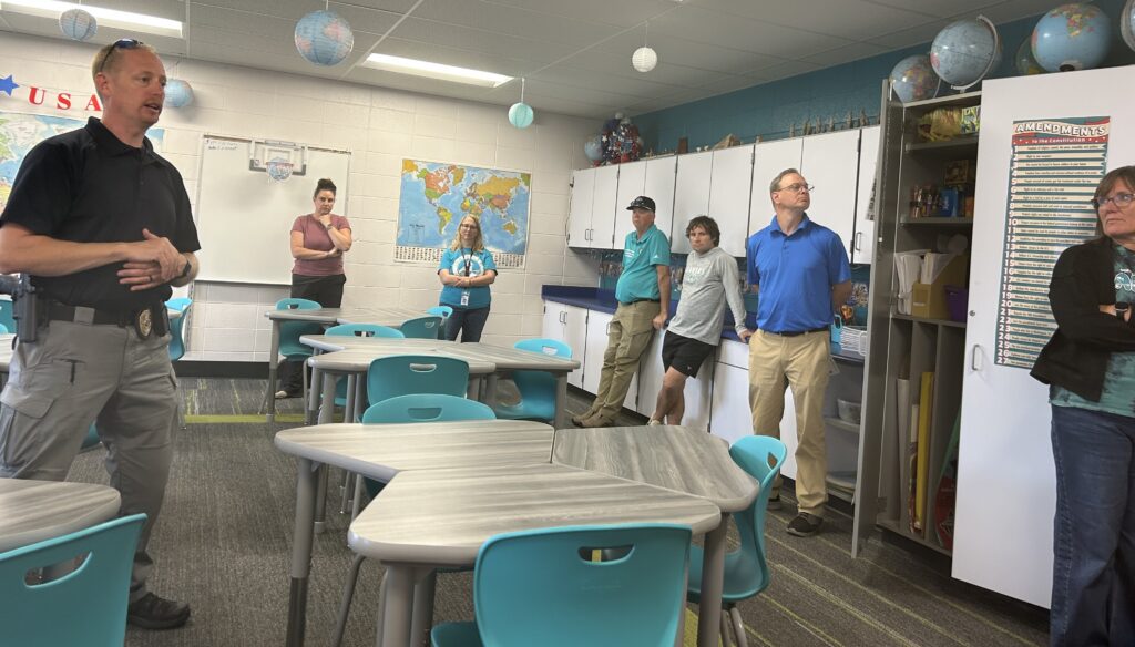 Safety training in classroom with police representative